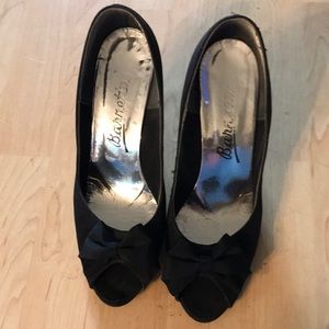 Wonen black heals with bow in front